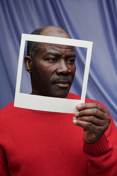 Holding Frame Against Blue Drapery Background