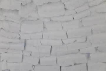 Abstract background. Inside igloo wall with the light shining through the edges of the ice blocks.
