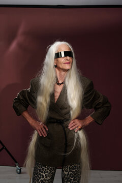 Portrait of Elderly Woman Posing with Long Hair in Studio