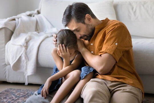 Loving father comforting little daughter, gives emotional support during challenging life moments, coping with hard period of life, going through relative death, embracing, sit close together on floor - Powered by Adobe