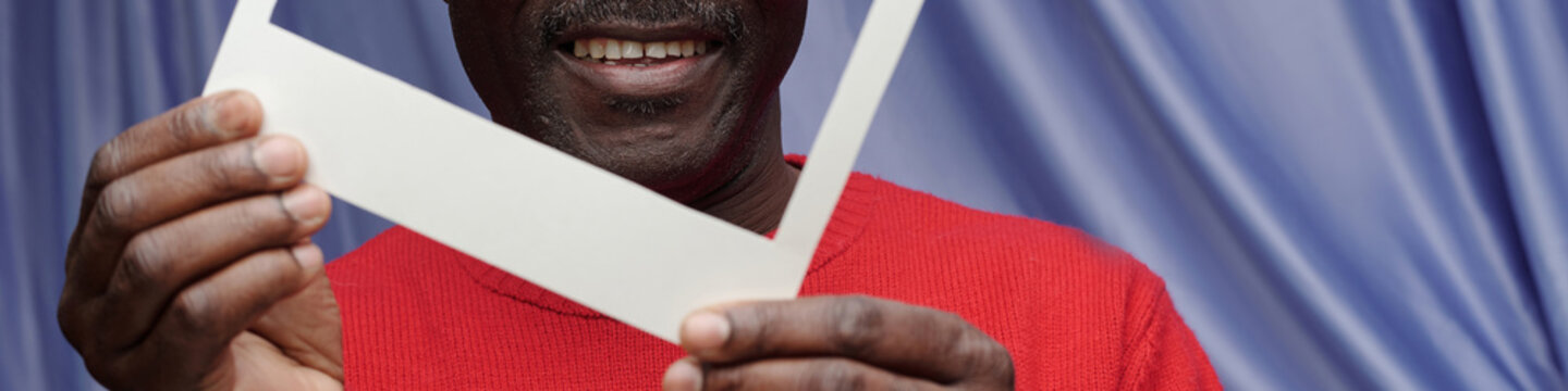Holding Blank Picture Frame with Red Sweater Smiling