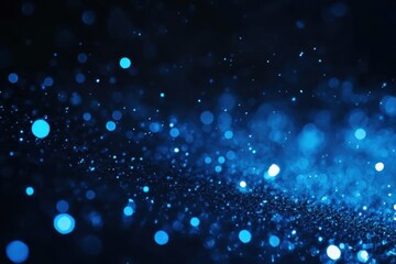 Obraz premium Sparkling blue particles dance in the light creating a mesmerizing cosmic effect across the dark backdrop. Generative AI