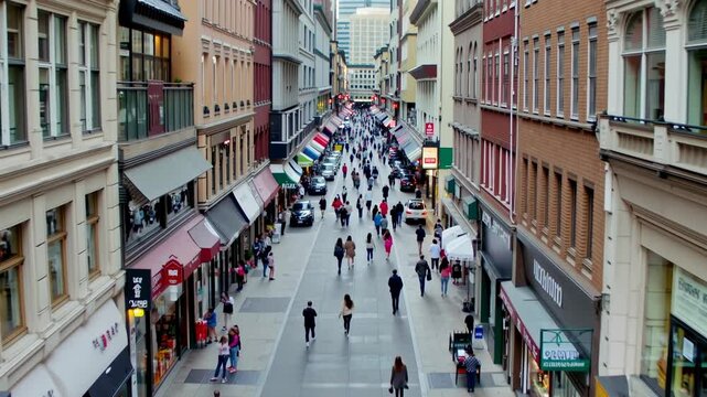 aereal wiew hyperlapse City Shopping Street Blur: A blurred background of a shopping street in the city with people walking, perfect for retail and urban lifestyle themes.