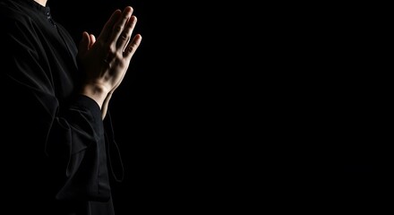 Silhouette of Person Praying in Darkness: A Moment of Faith and Serenity