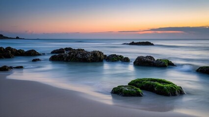 Fototapeta premium Sunset white sand beach with rock foreground