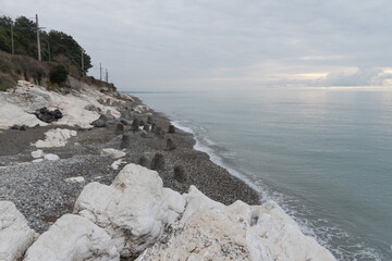 White cliffs on the Black Sea coast near Gagra, Abkhazia, with pebbled shore and calm water