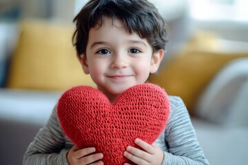 Valentine's day greeting and funny gift. Beam face cute child boy with big knitted heart in hands. Heartfelt emotions. Love celebration photography. Adorable child surprise. Valentineâ€™s joy.