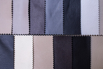 Colorful samples of upholstery fabrics close-up. Leather swatches for furniture renovation