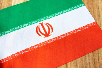 Iran national flag on the wood natural background.