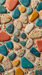 Abstract terrazzo background with colorful stone chips in coral, teal, and mustard yellow, set against a smooth, off-white surface for a modern mid-century vibe.