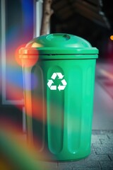 Obraz premium Green recycling bin with recycle logo for disposing of paper, metal, glass and plastic for processing.