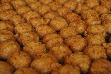 Golden, crispy fried meatballs in bubbling oil. Indonesian Street Food.