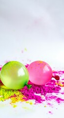 Colorful balloons on vibrant powder with splashes of pink and green for Holi festival celebration