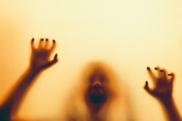 Shadowy figure, child behind glass - horror background
