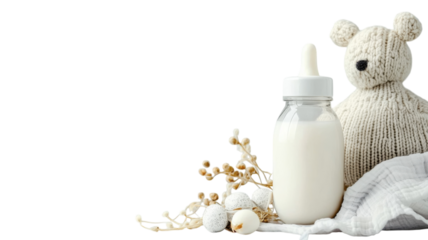 Cozy baby essentials displayed with a knitted bear and a milk bottle surrounded by decorative elements