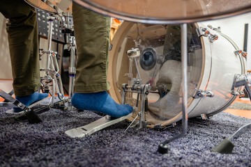Person's foot playing kick drum in recording studio