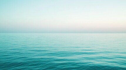Obraz premium Serene Ocean Horizon: Tranquil Waters Meeting the Sky at Dawn or Dusk