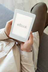 Man reading ebook. Modern digital e-book tablet with electronic ink technology for relaxation, education and business.