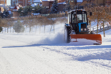 Snow removal machine clears the way in a cottage town after heavy a snowfall.