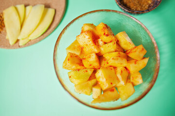 Pickled mango cubes in a bowl, mango pickle, shot from above