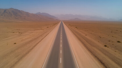 Fototapeta premium deserted highway stretches through vast desert landscape, surrounded by mountains and arid terrain, evoking sense of solitude and adventure