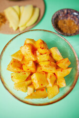 Pickled mango cubes in a bowl, mango pickle, shot from above