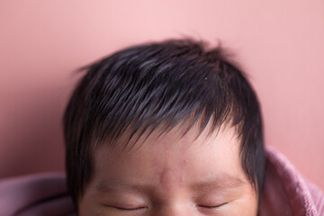 Top of human newborn baby head forehead