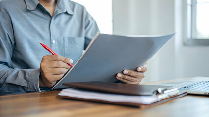Accountant in silent room re checks records to spot VAT errors to avoid striving for perfect correctness in each submission concept as Gray folder red pen circling entries careful scrutiny prevents co