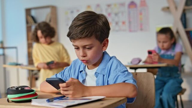 Children using gadgets classroom at group activity. Students elementary school