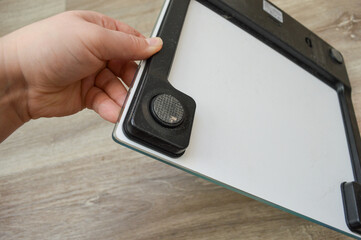 person standing barefoot digital bathroom scale kilograms blue watercolor design weight loss gain fitness tracking BMI monitoring healthy lifestyle fitness sports diet healthcare obesity awareness 