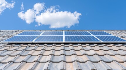 Solar panels on tiled roof, blue sky, clouds.  Clean energy home