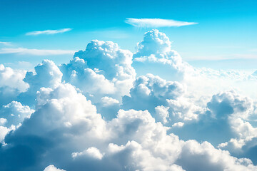 Fototapeta premium Expansive view of fluffy white clouds against a bright blue sky, evoking a sense of tranquility and freedom