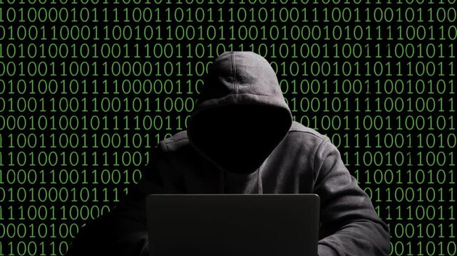 Hacker in Hoodie with Binary Code Background &ndash; Cybersecurity and Cybercrime Concept