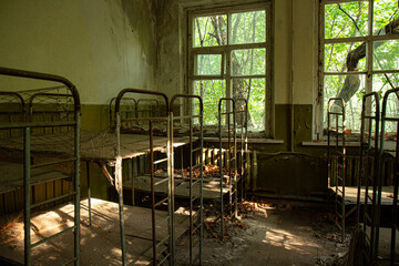 Rusty metal beds and peeling wall colors within a kindergarten in the Chernobyl exclusion zone