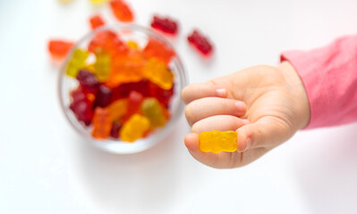 Child eating jelly candies at home. Selective focus.