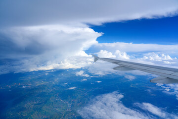 Fluffy clouds as seen through window an airplane. Wing View from the airplane beautiful cloudy sky...