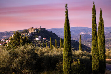 Montegiovi hilltop village with cypress trees in Tuscany Ancient stone buildings olive groves...