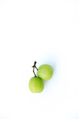 Fresh green grapes on a twig, isolated on a clean white background. Bright lighting highlights their natural, translucent quality