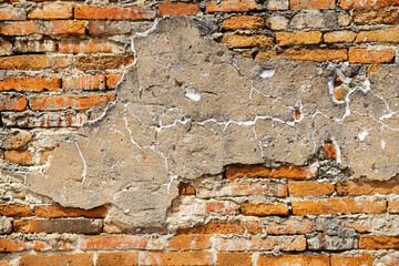 Weathered Brick Wall with Cracked Cement and Textured Surface Detail