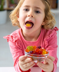 Child eating jelly candies at home. Selective focus.