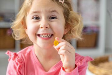 Child eating jelly candies at home. Selective focus.