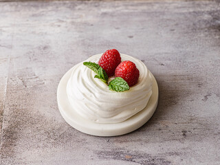 pavlova meringue dessert with raspberries and cream