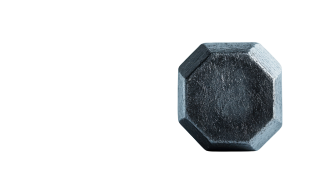 Unique octagonal metal object displayed on a clean surface with soft lighting in a minimalistic setting