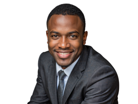 A man in a suit and tie poses in front of a neutral background