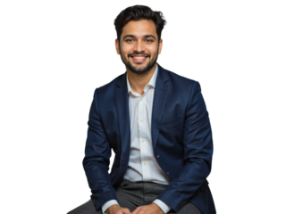 A young man in a navy blue blazer and white dress shirt sits against a transparent background