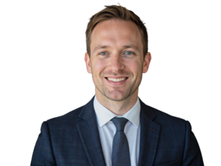 A formally dressed man in a blue suit and tie smiles warmly against a transparent background