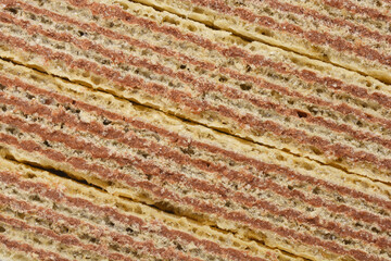 A close-up shot of cocoa wafer biscuits reveals their layered texture and rich chocolate filling, emphasizing their crunchy and sweet appeal