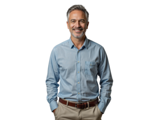 A man wearing a light blue button-down shirt and khaki pants stands in front of a plain background, smiling warmly.