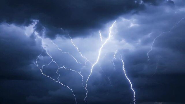 Dramatic thunderstorm lightning flashes across dark skies in night storm