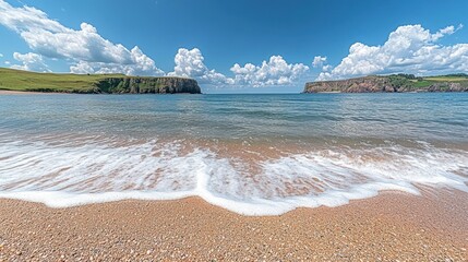 Sunny beach waves meet calm coastal cliffs